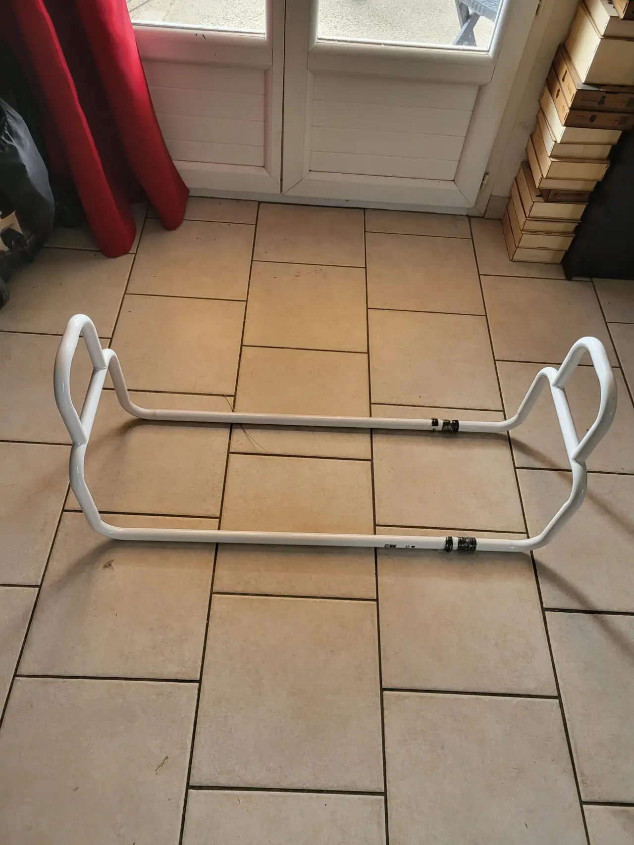 Releveur de lit en métal laqué blanc, état neuf, doté de deux poignées latérales ergonomiques et